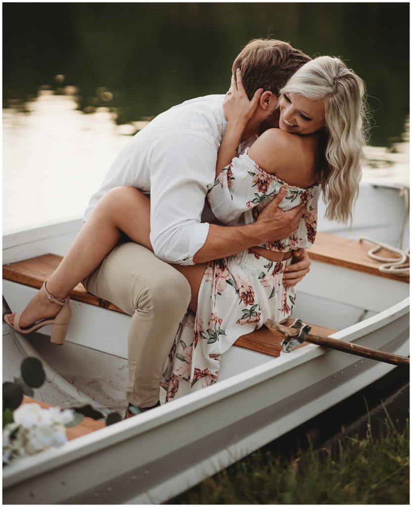 couple hugging and laughing during boat ride on tennessee river
