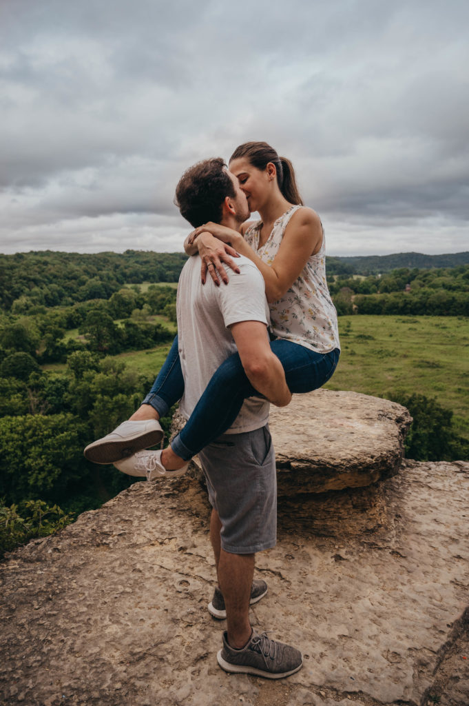 Man and woman embracing and kissing hugging on top of mountain in Nashville