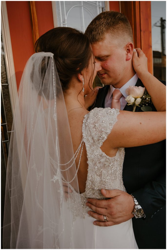 bride and groom embracing one another on wedding day celebrating their recent elopement