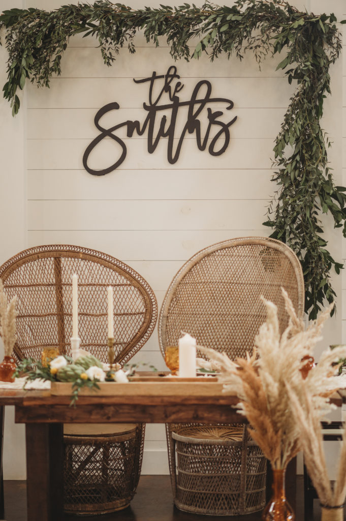 sweetheart table with greenery and boho chic wedding decor at barn at white oaks