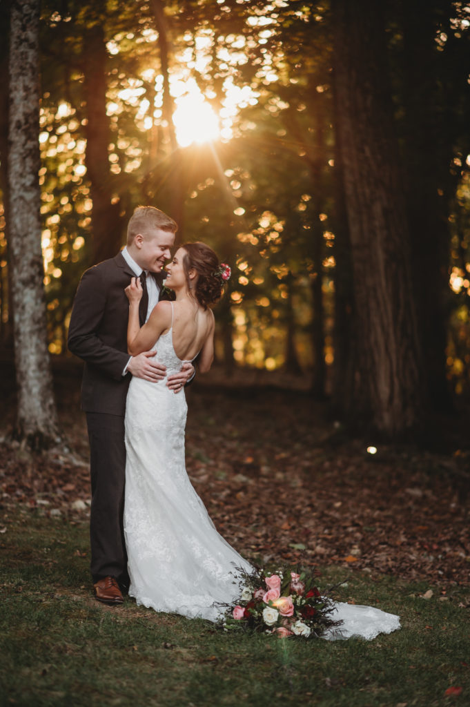 bride and groom posing in tennessee forest after micro wedding celebration
