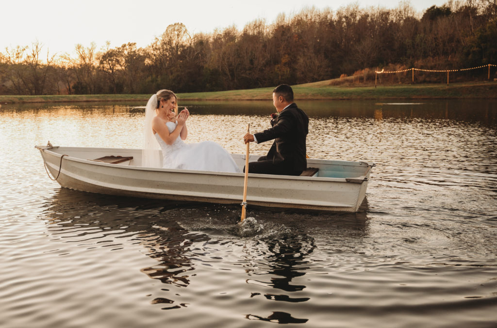 bride and groom rowing a boat on wedding day at beautiful nashville venue