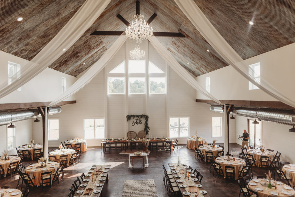 inside the barn at white oaks venue set up for reception after Kentucky wedding