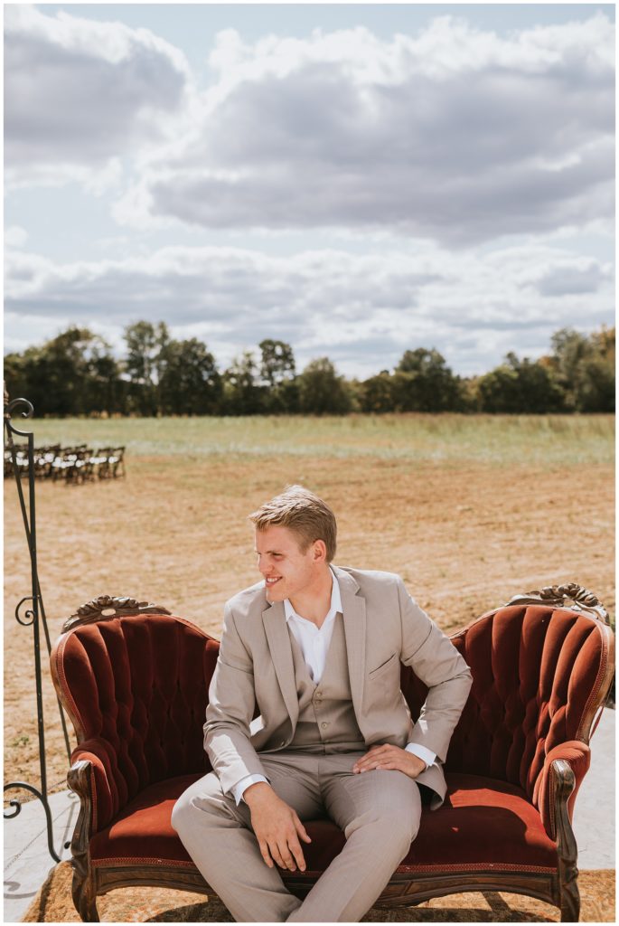 groom sitting on couch before wedding day