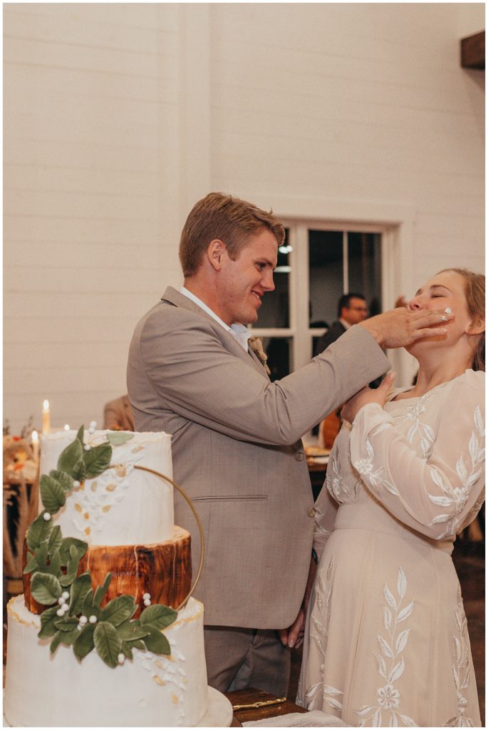 groom putting cake in bride's mouth