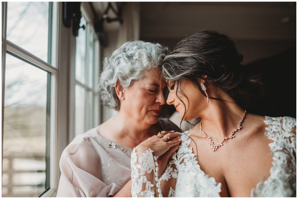 bride and her mother hugging on wedding day