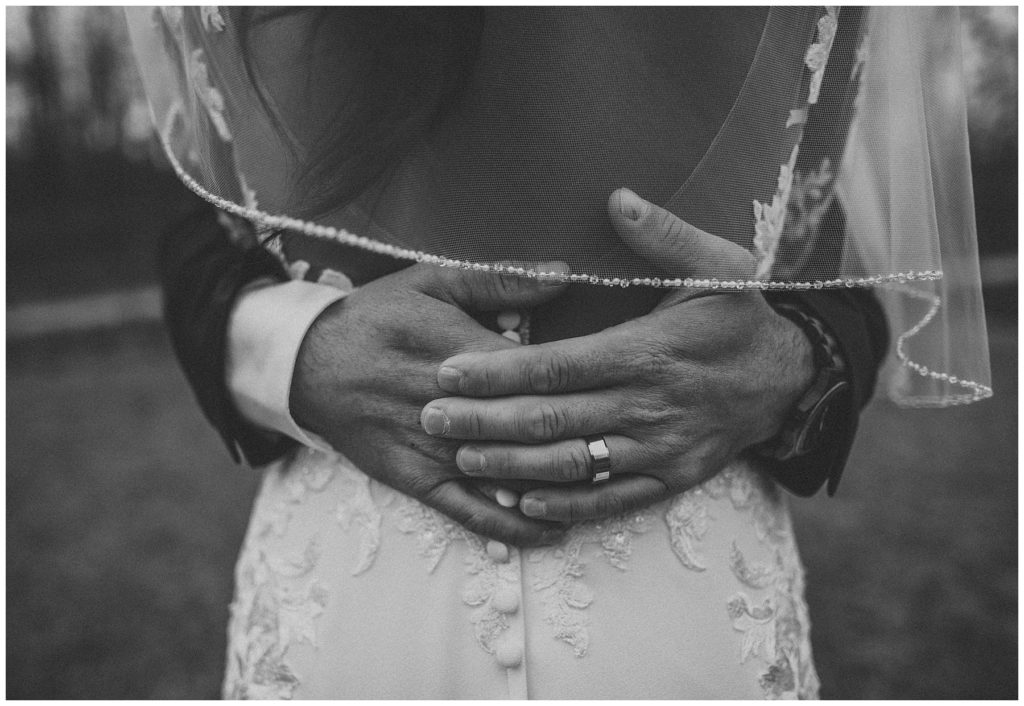 groom's hands holding bride's back