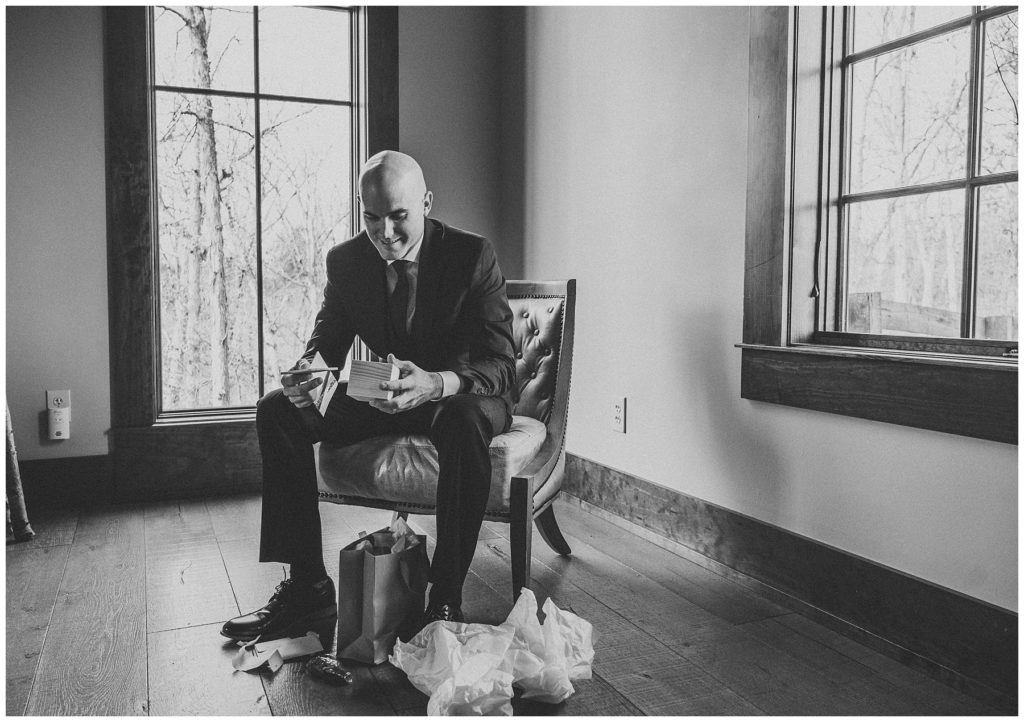 groom sitting on chair getting ready for wedding day
