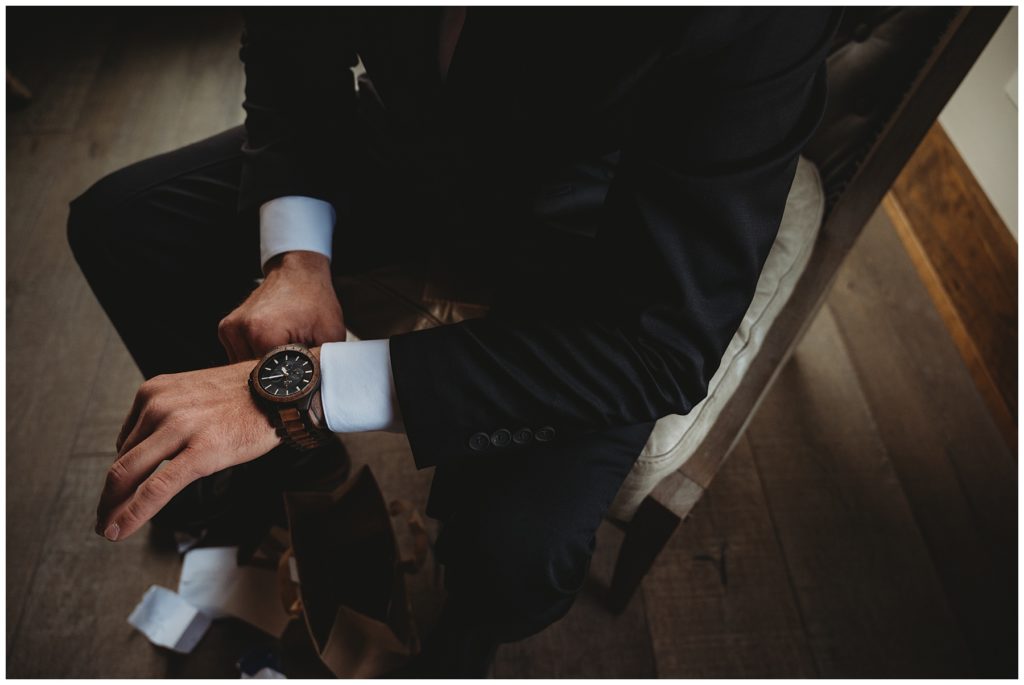 groom adjusting watch while getting ready