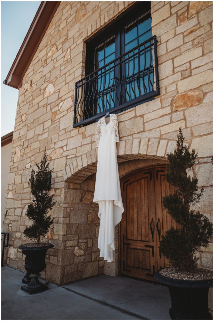 wedding gown hanging from venue window