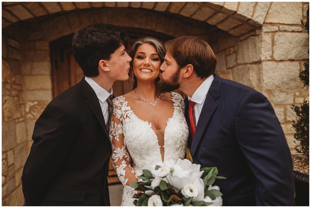 bride being kissed by family on the cheek