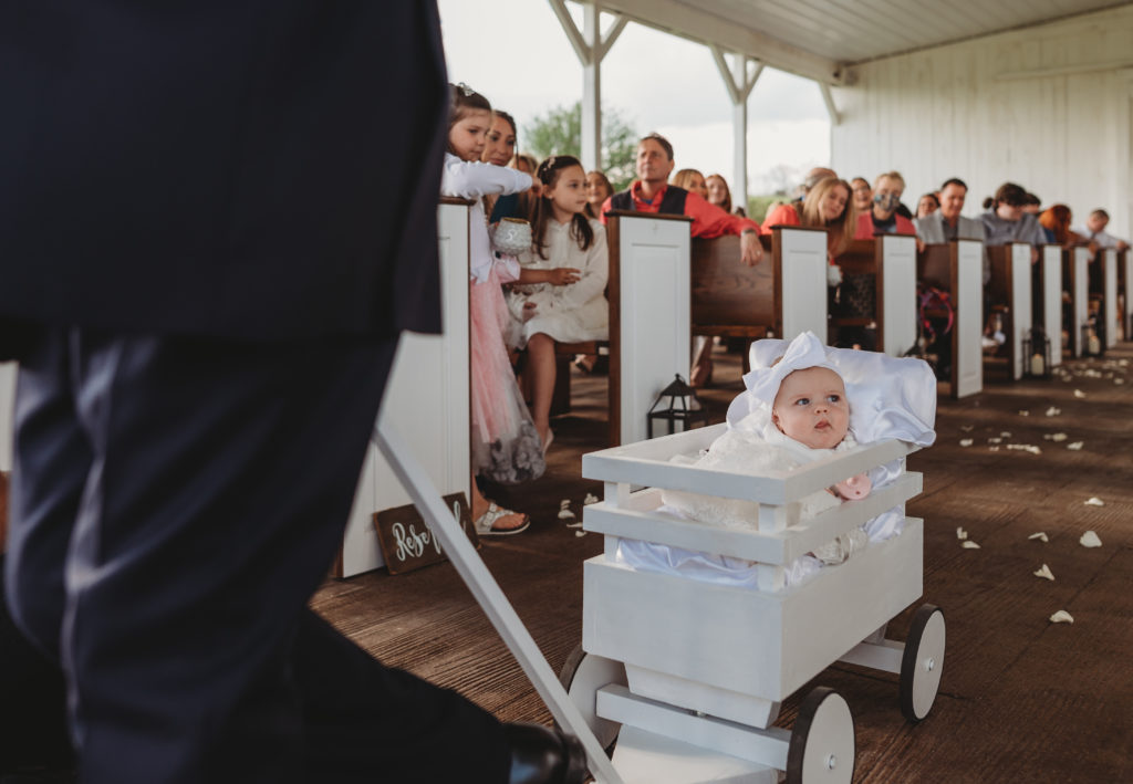 flower girl baby in a wagon. Barn wedding in Tennessee