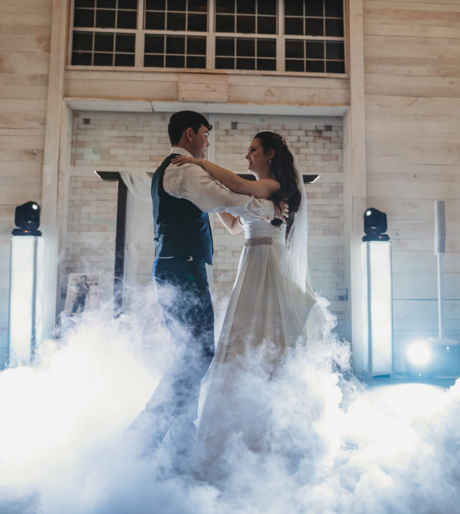 bride and groom dancing on clouds for their first dance on their wedding day in Tennessee in the White Dove Barn in Beechgrove, Tennessee