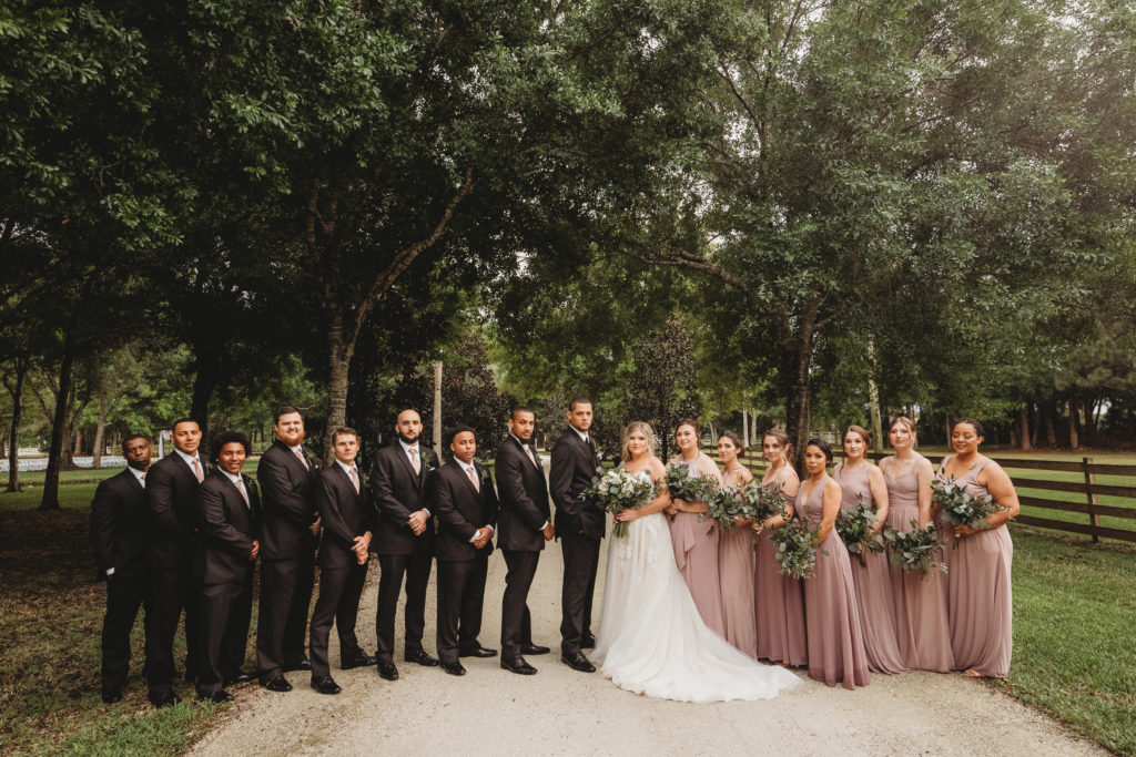 Florida bridal party standing on a dirt trail in Vero beach on their wedding day