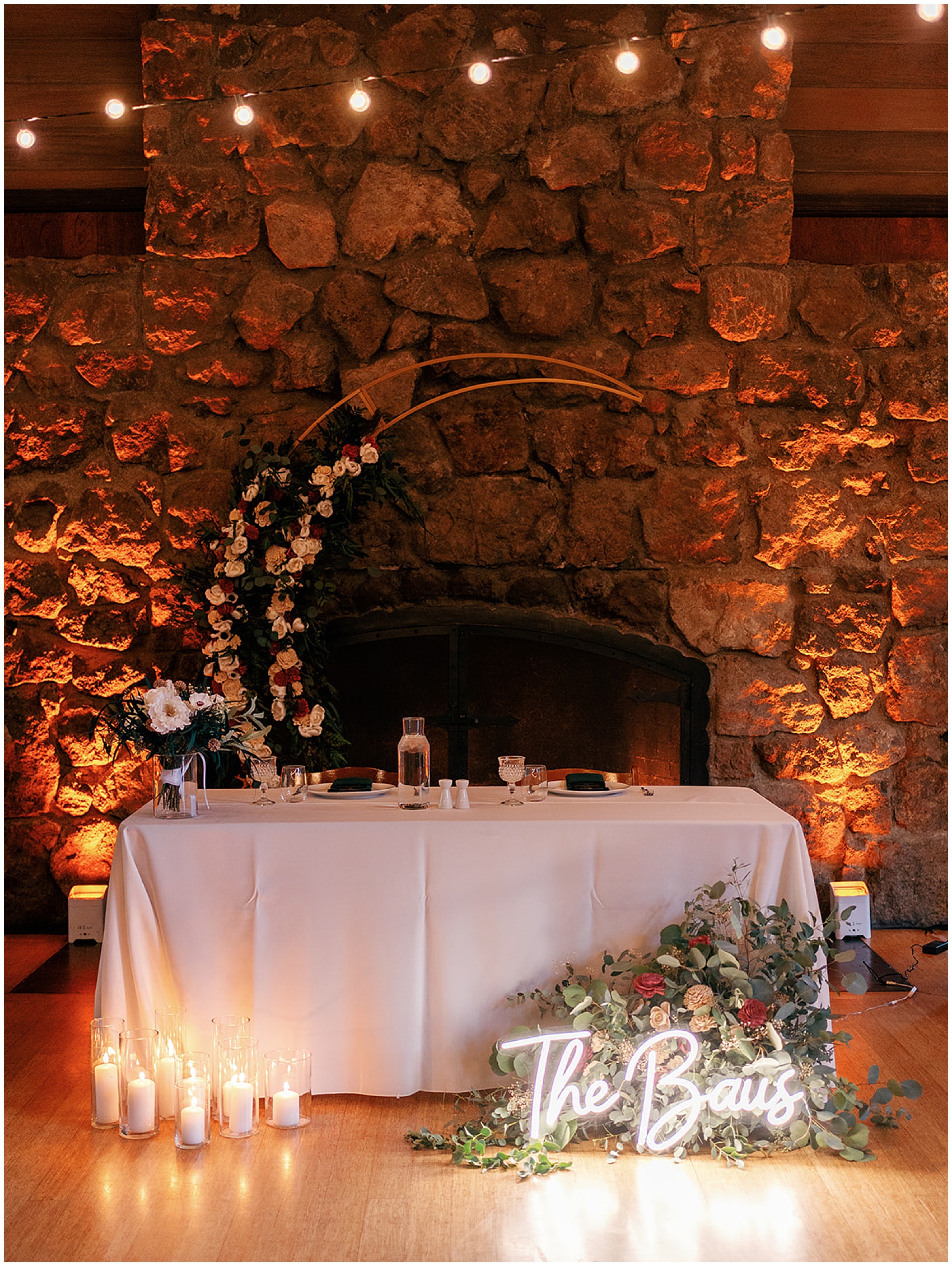 Details of a wedding reception head table setu up with lighting and candles at a brazilian room tilden park wedding