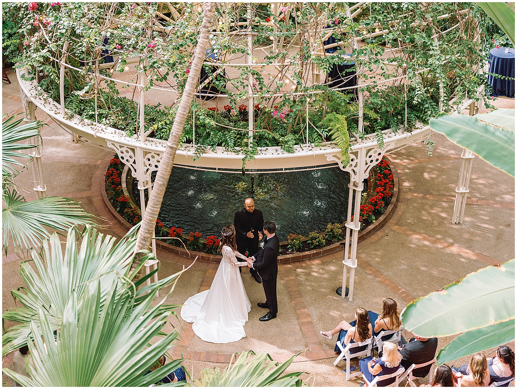 An overhead look at a bride and groom holding hands during their gaylord opryland wedding wedding ceremony