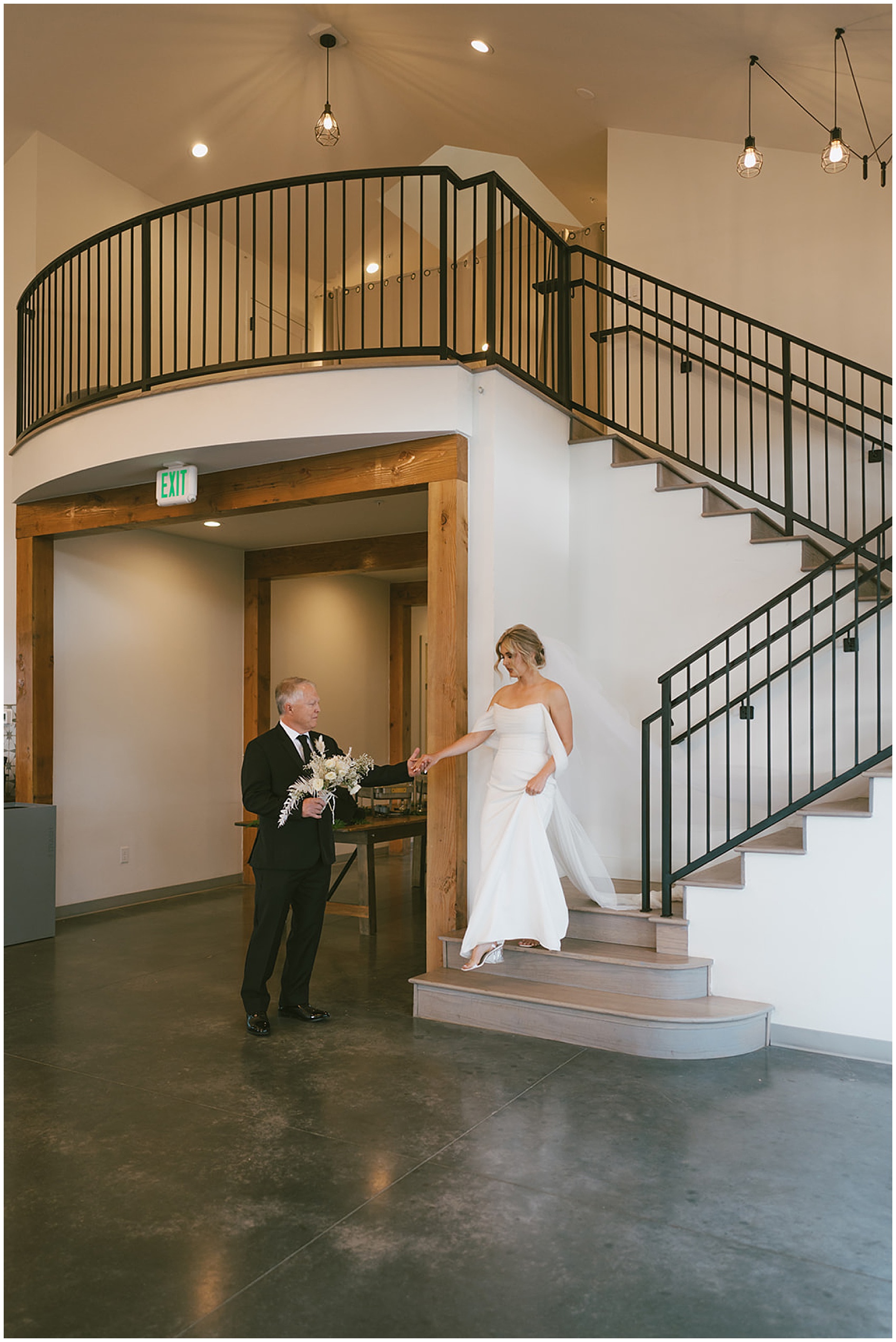A father walks his daughter down the stairs of the north star gatherings wedding venue for her ceremony