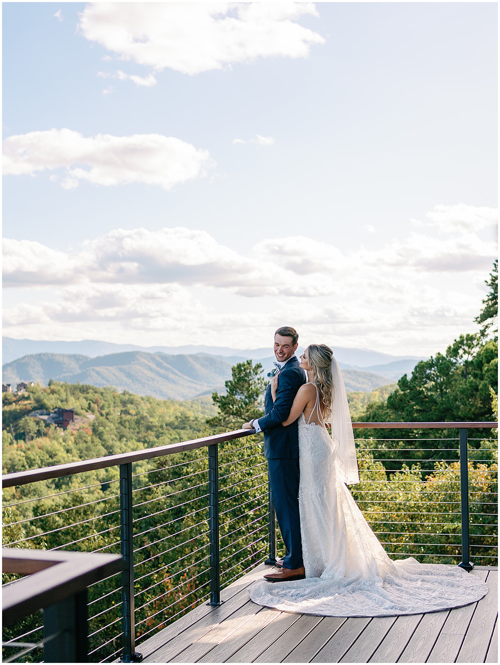 Newlyweds share a happy intimate moment a overlooking the mountains from the the trillium venue patio