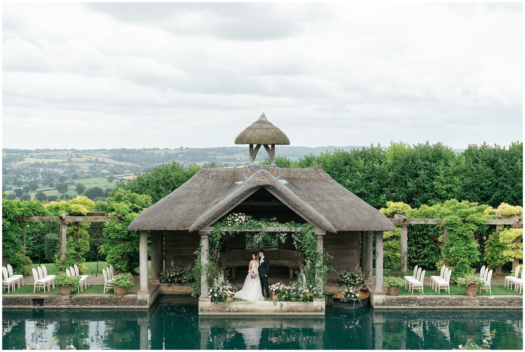 Newlyweds stand in the pool house after their lakeside ceremony at their Euridge Manor wedding