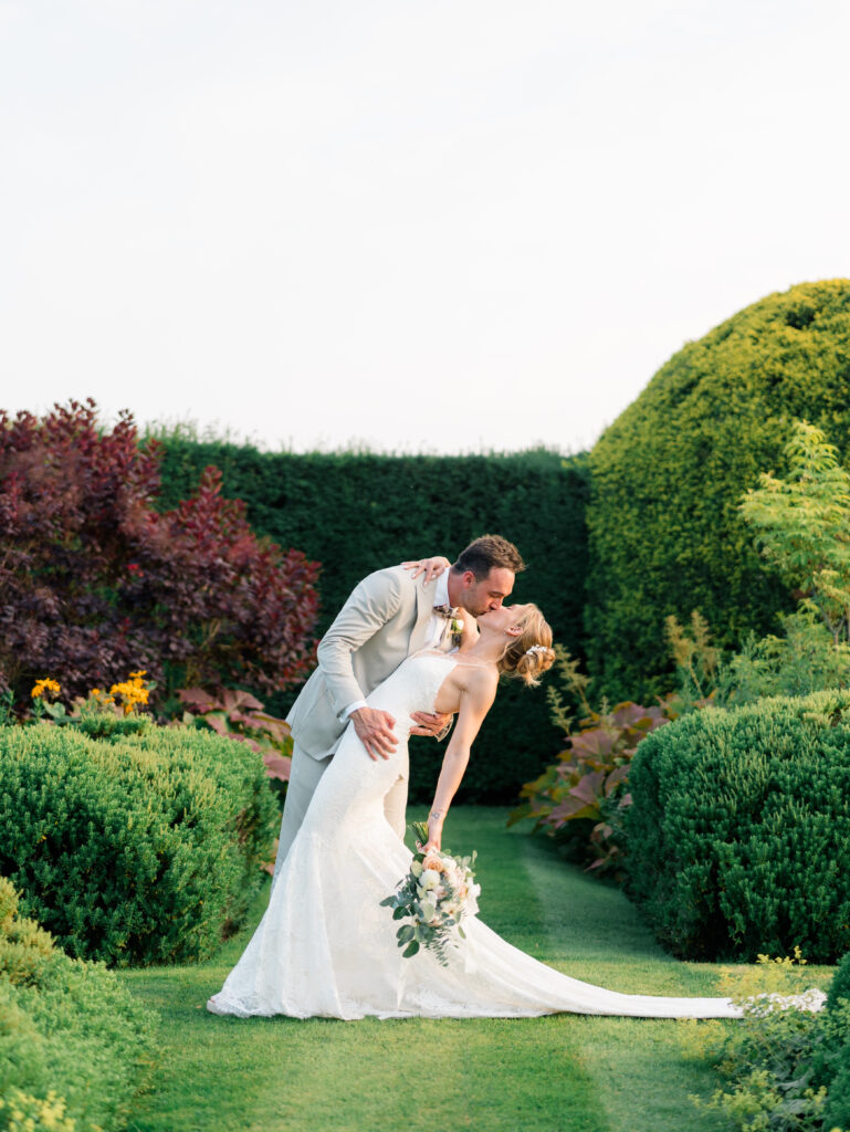 Romantic portrait of groom dipping bride for a kiss.